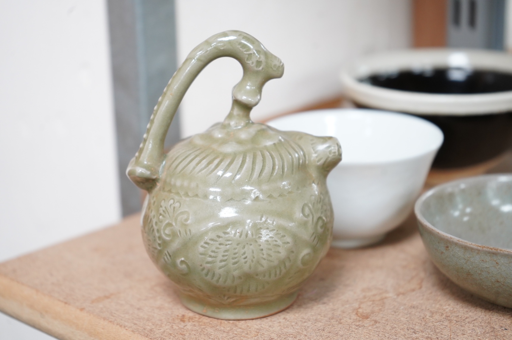 A collection of Chinese porcelain and pottery to include a naturalistic teapot, crackle glaze bowl and a ‘dragon’ bowl, largest 10cm in diameter